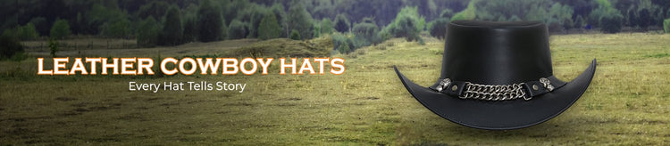 "A black leather cowboy hat with a decorative band sits in a field."