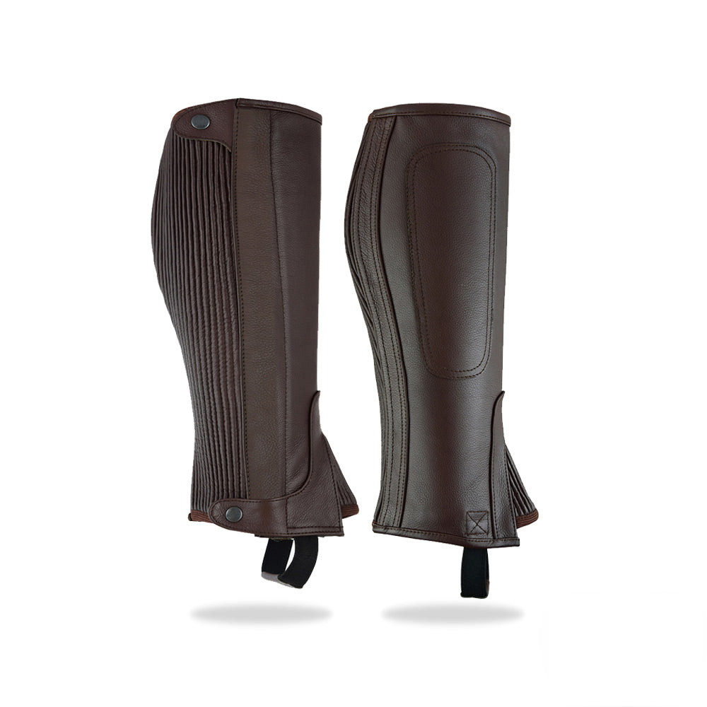 A slightly angled view of the brown leather ribbed half chaps, highlighting the color and texture of the leather.
